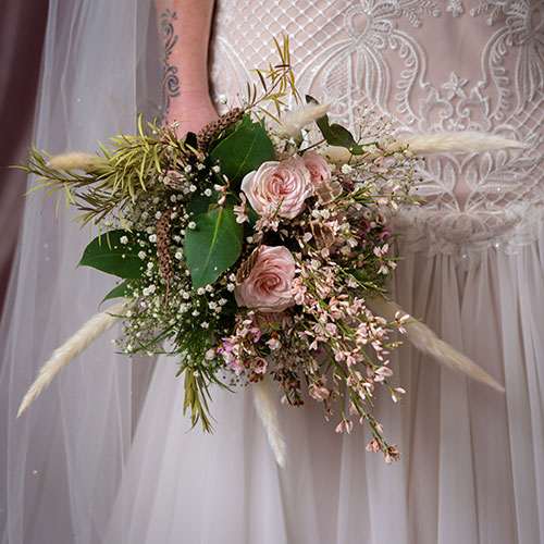 a bridesmaid holding a bouquet
